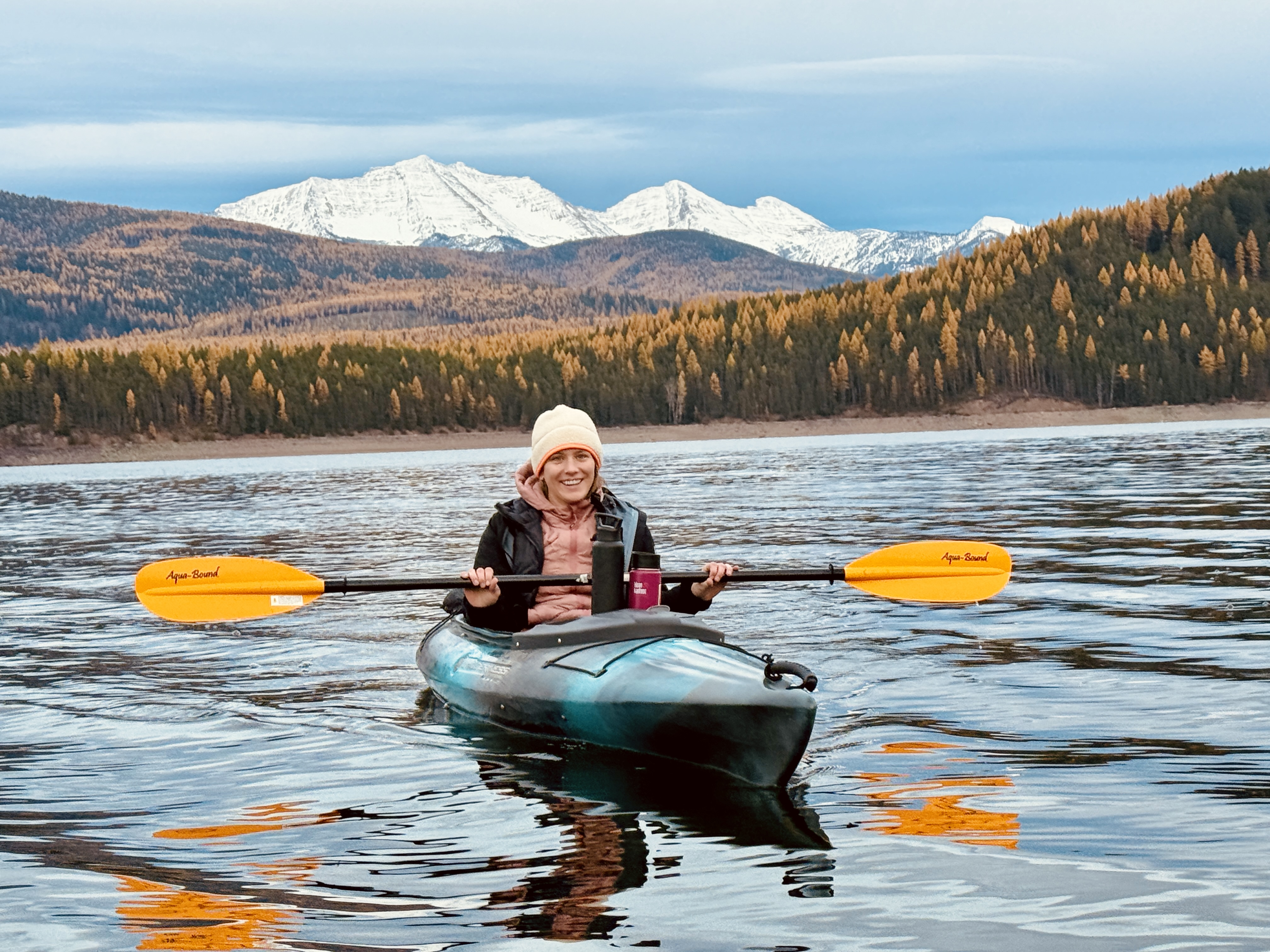 Kayaking on a Montana lake with snow-capped peaks